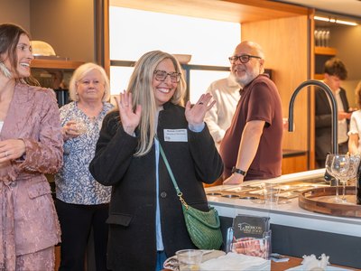 Guests with plates and glasses beside the counter