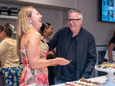Two guests laughing together beside the tapas